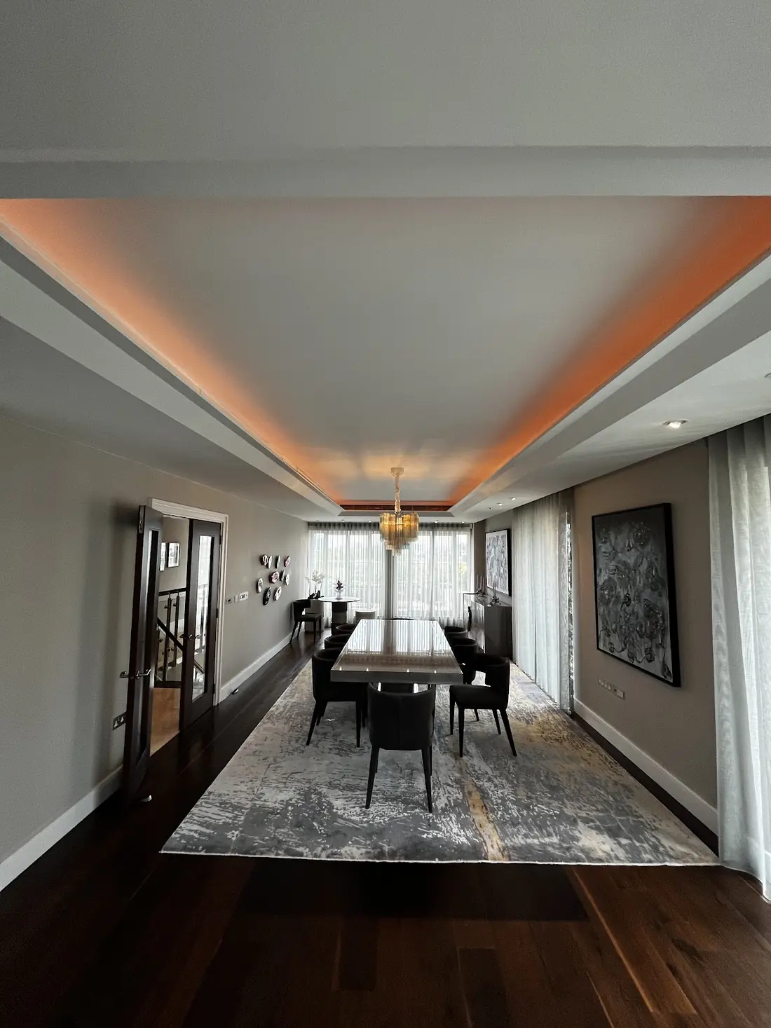 Dining room with matching colour-changing cove lighting shown in amber