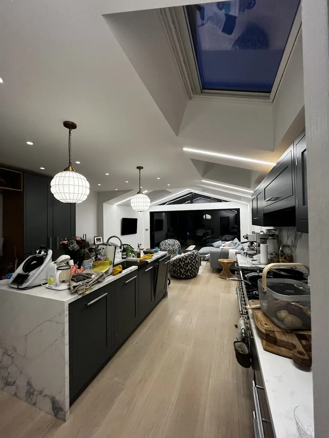 Modern kitchen extension with skylight, LED strip lighting and globe pendants