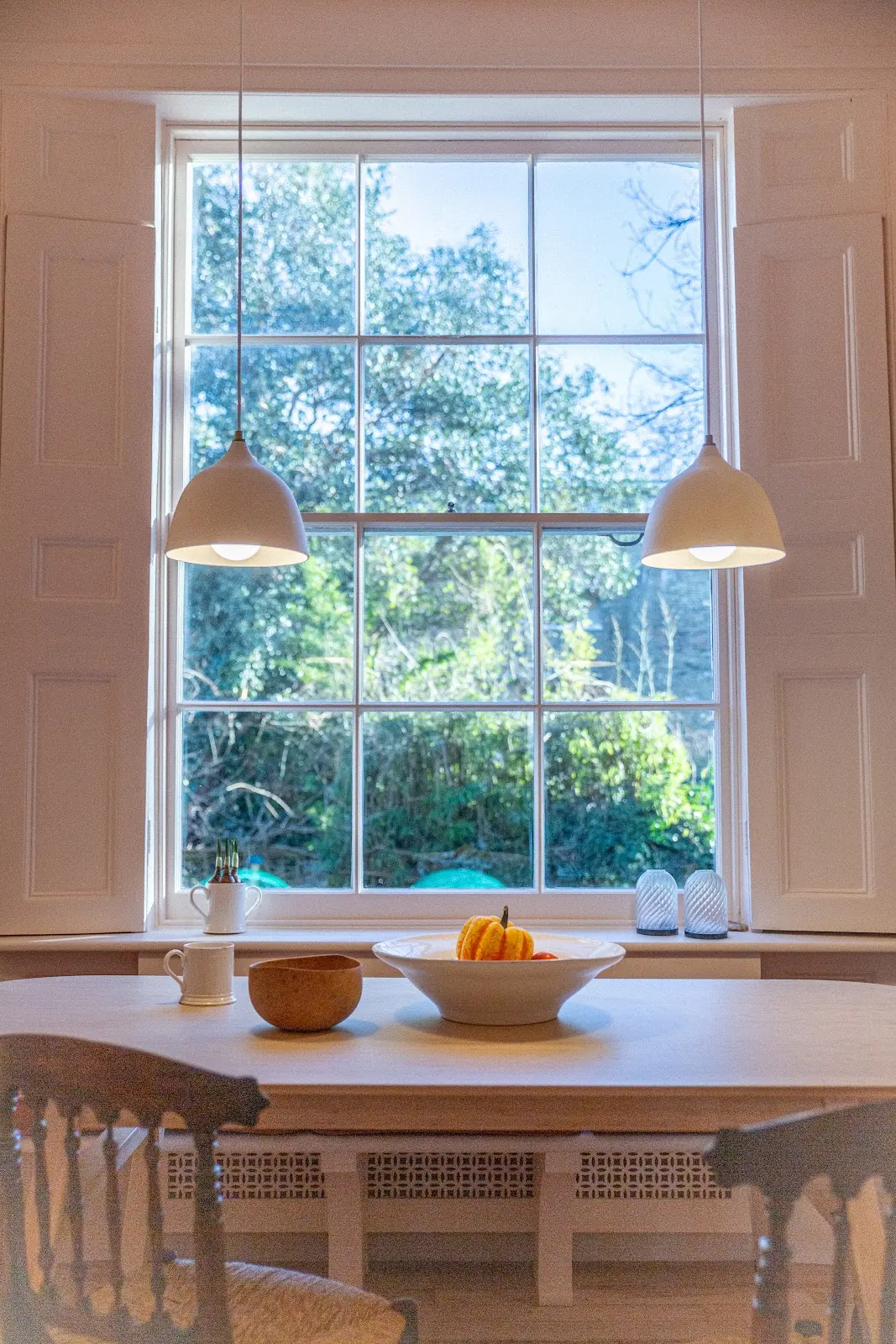 Traditional kitchen with new pendant lighting over the dining table